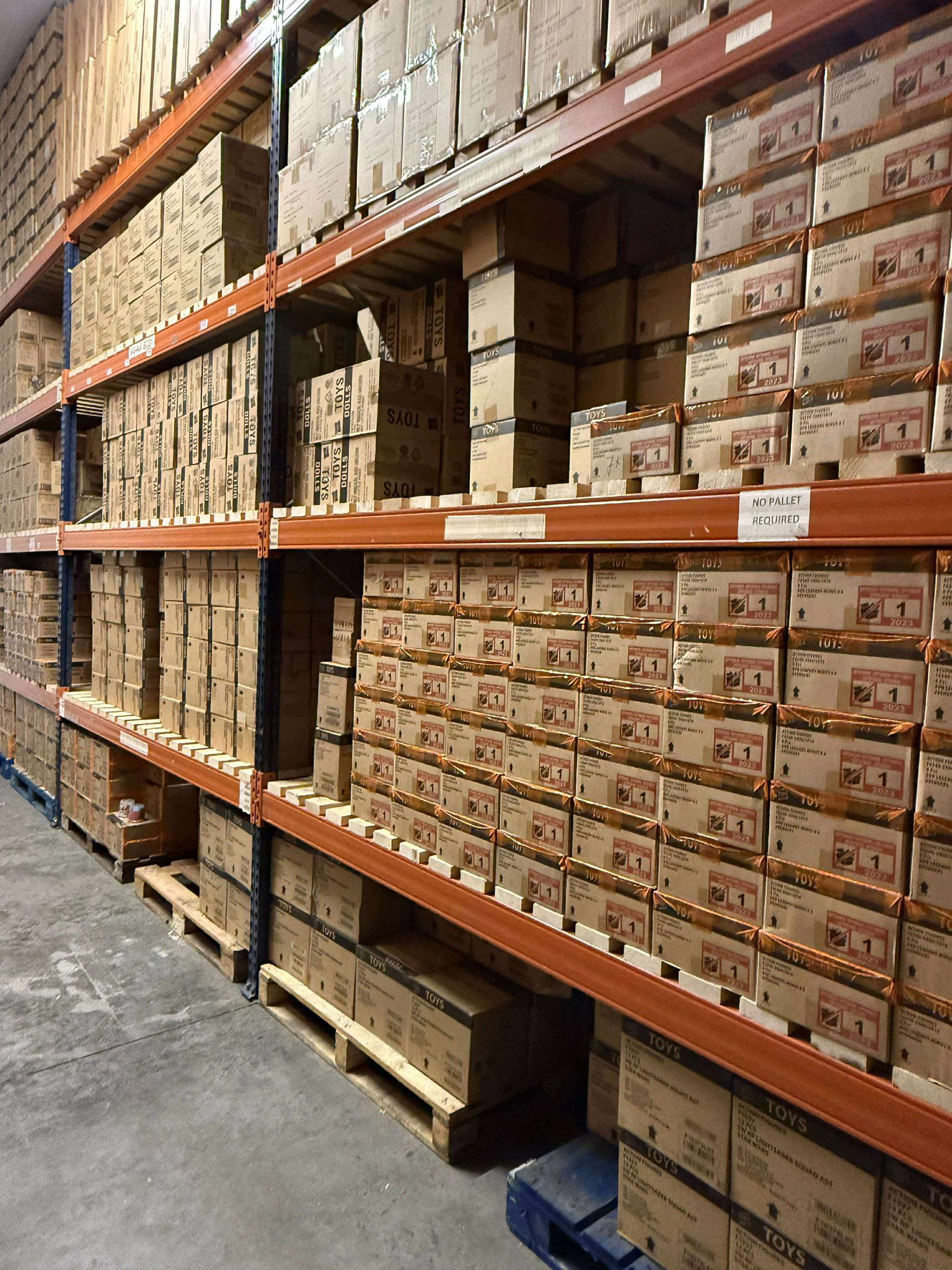 man pulling pallete in warehouse